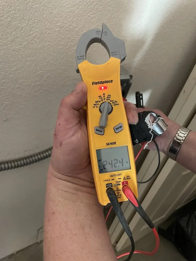 Voltage testing with clamp meter during Outlet Installation in Philadelphia